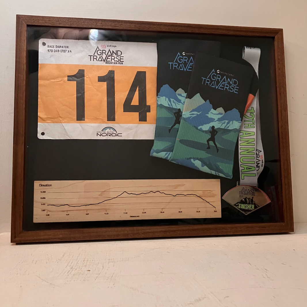 Mitered walnut frame with an acrylic cover to show off race memorabilia.
