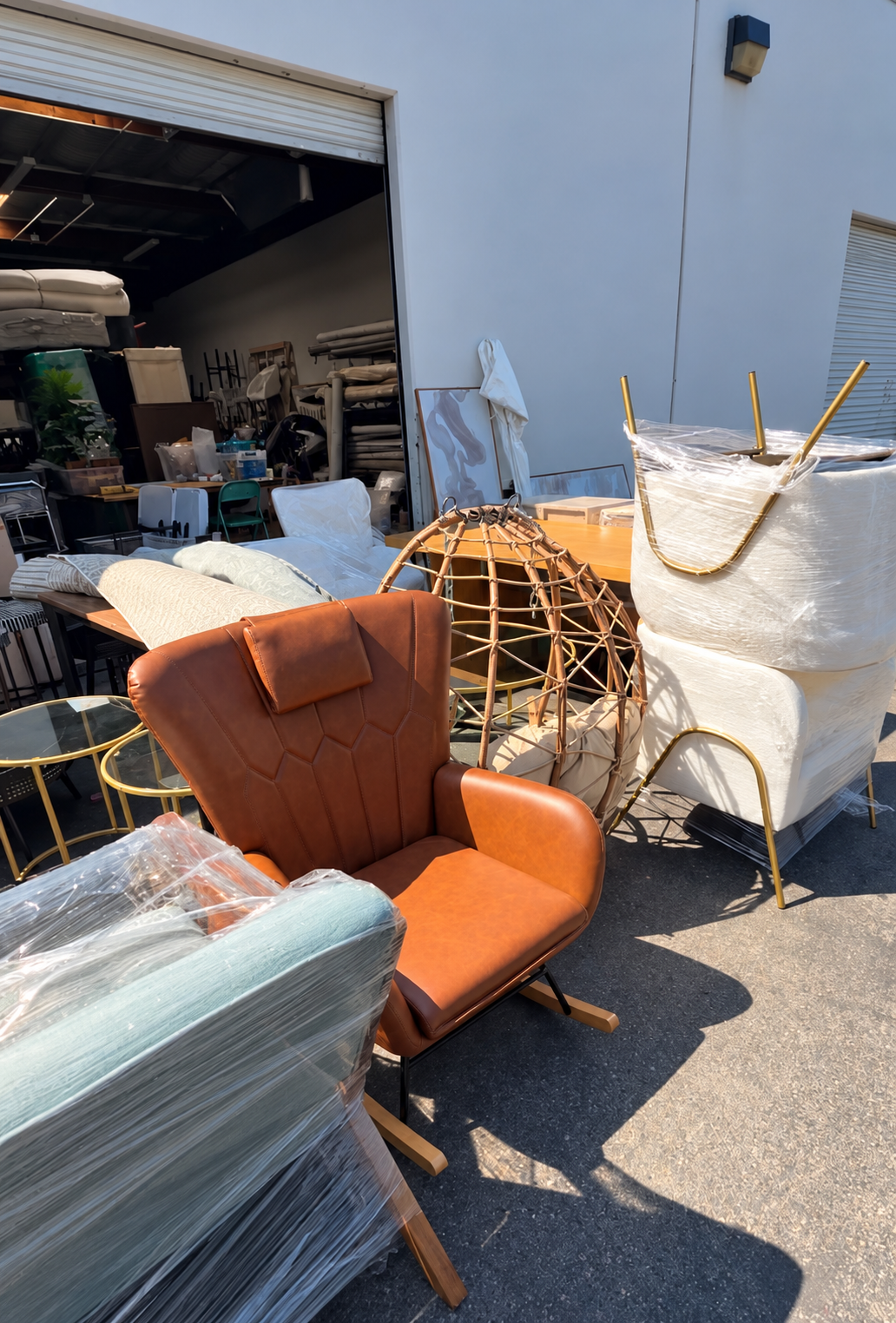 Home staging furniture, accent chairs, rugs, and accessories being prepared for installation outside the Haus of Heidi warehouse in Oceanside, California.