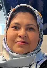 Woman with patterned headscarf posing indoors
