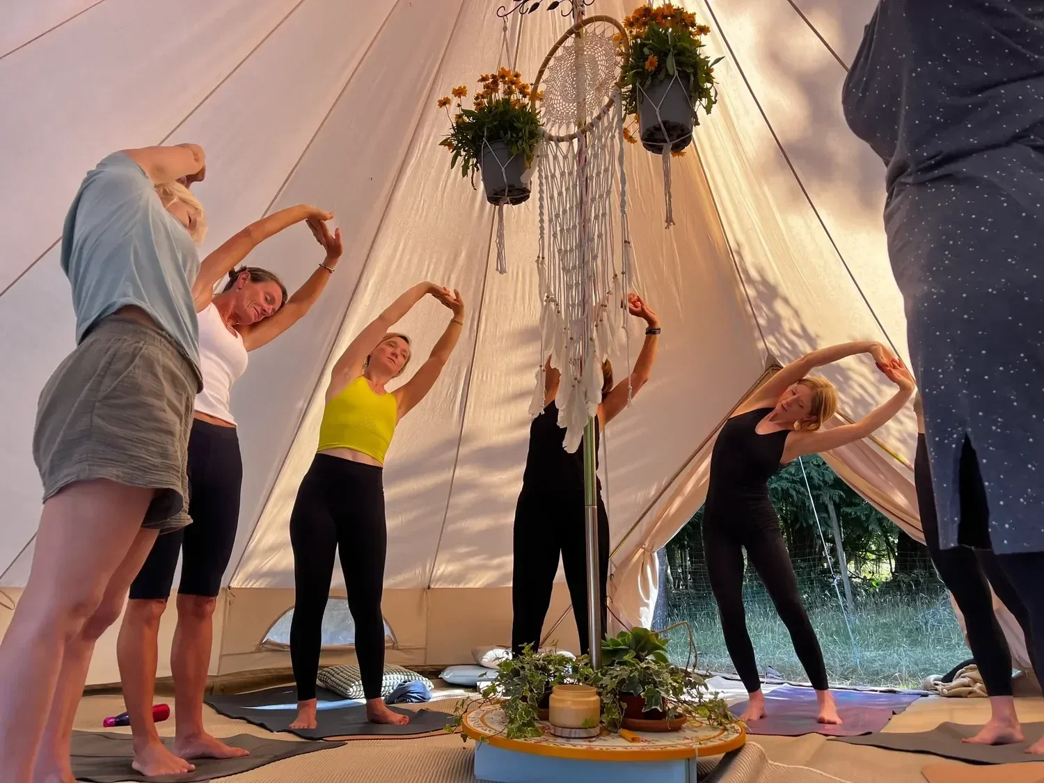 yoga stretching move in a bell tent at the enwild retreat nature and wellness retreat oxfordshire