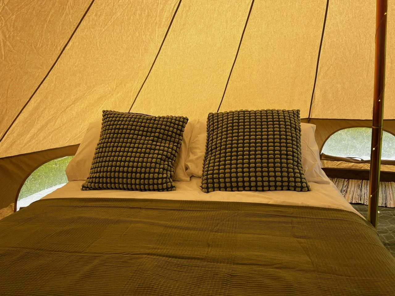 enwild glamping 4m bell tent with double bed.webp