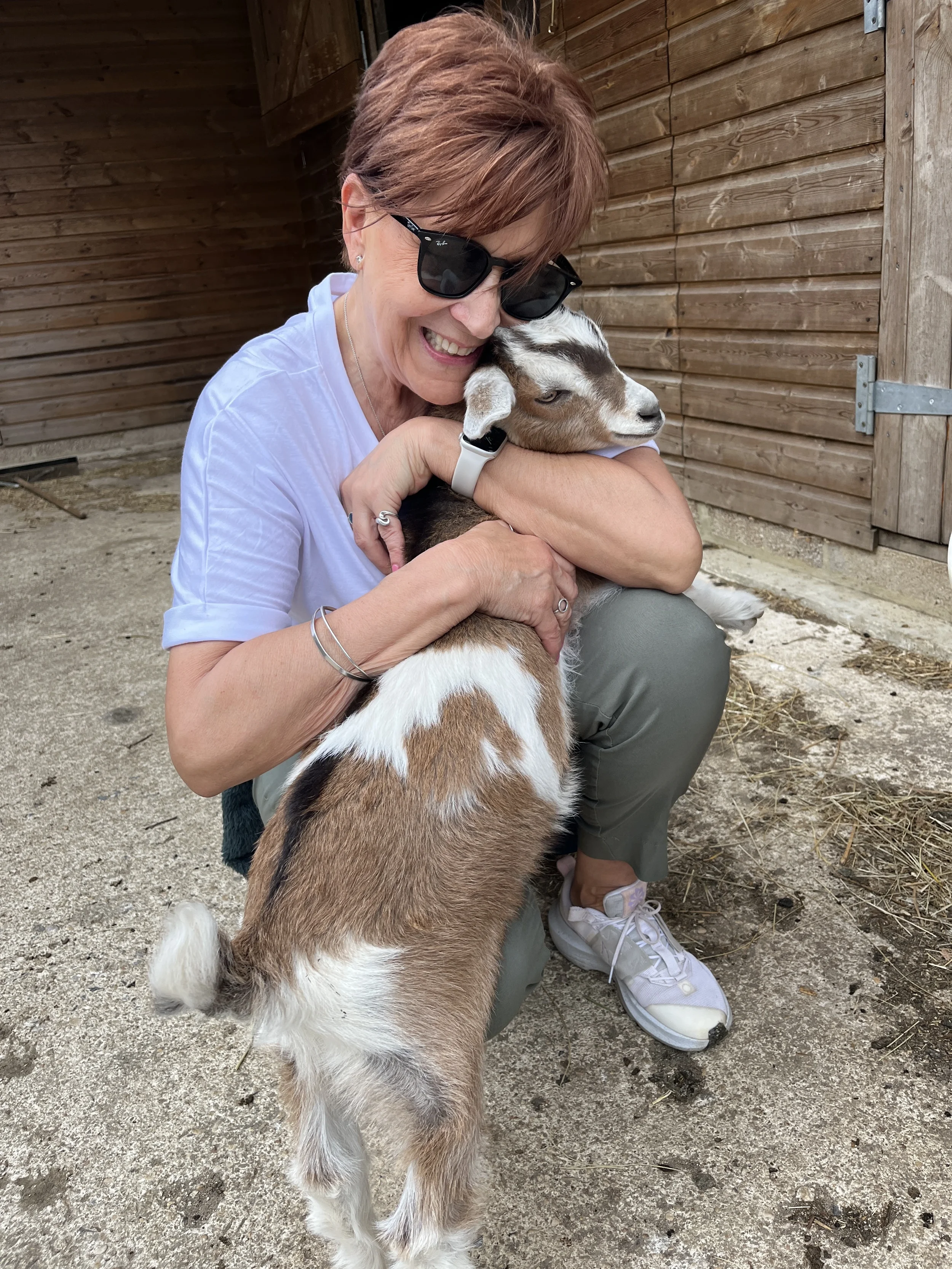 enwild retreat guest cuddle the goats.webp