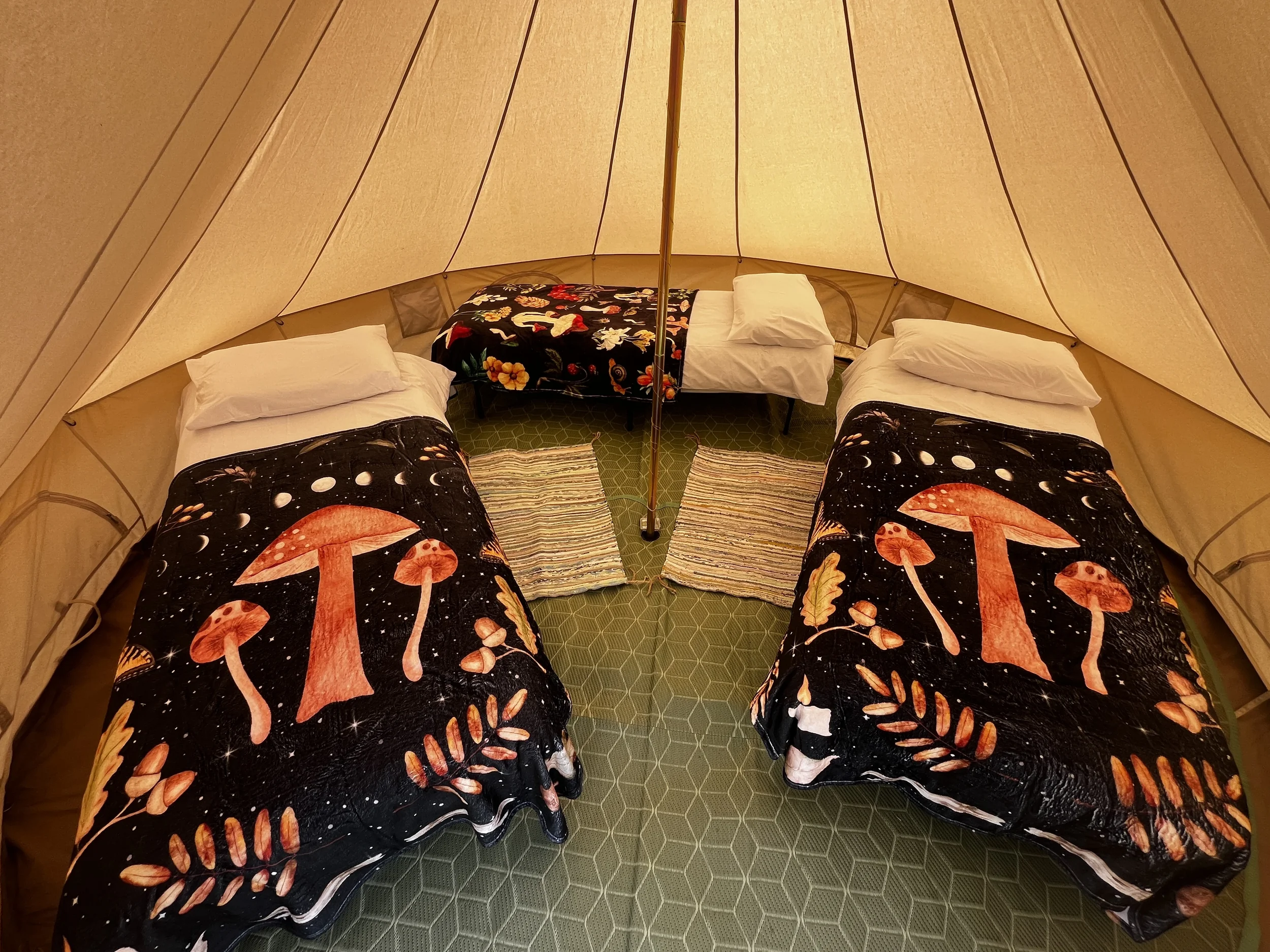 enwild glamping 4m bell tent with 3 single beds.webp