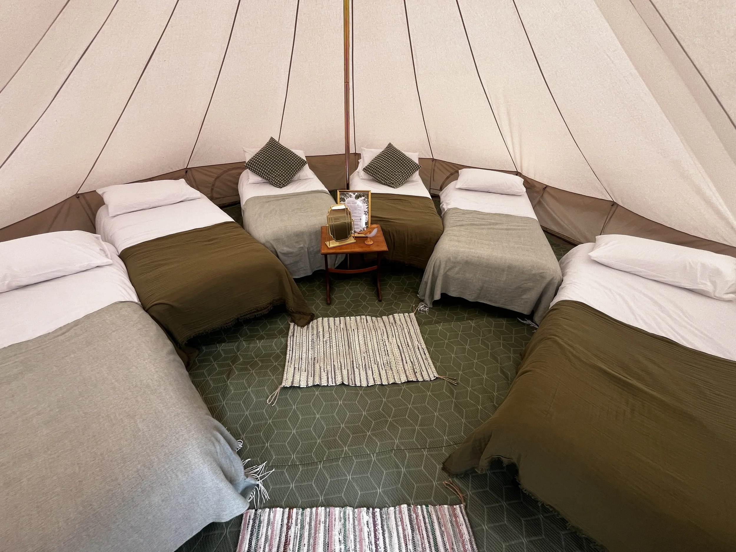 enwild glamping 5m bell tent with 6 single beds.webp