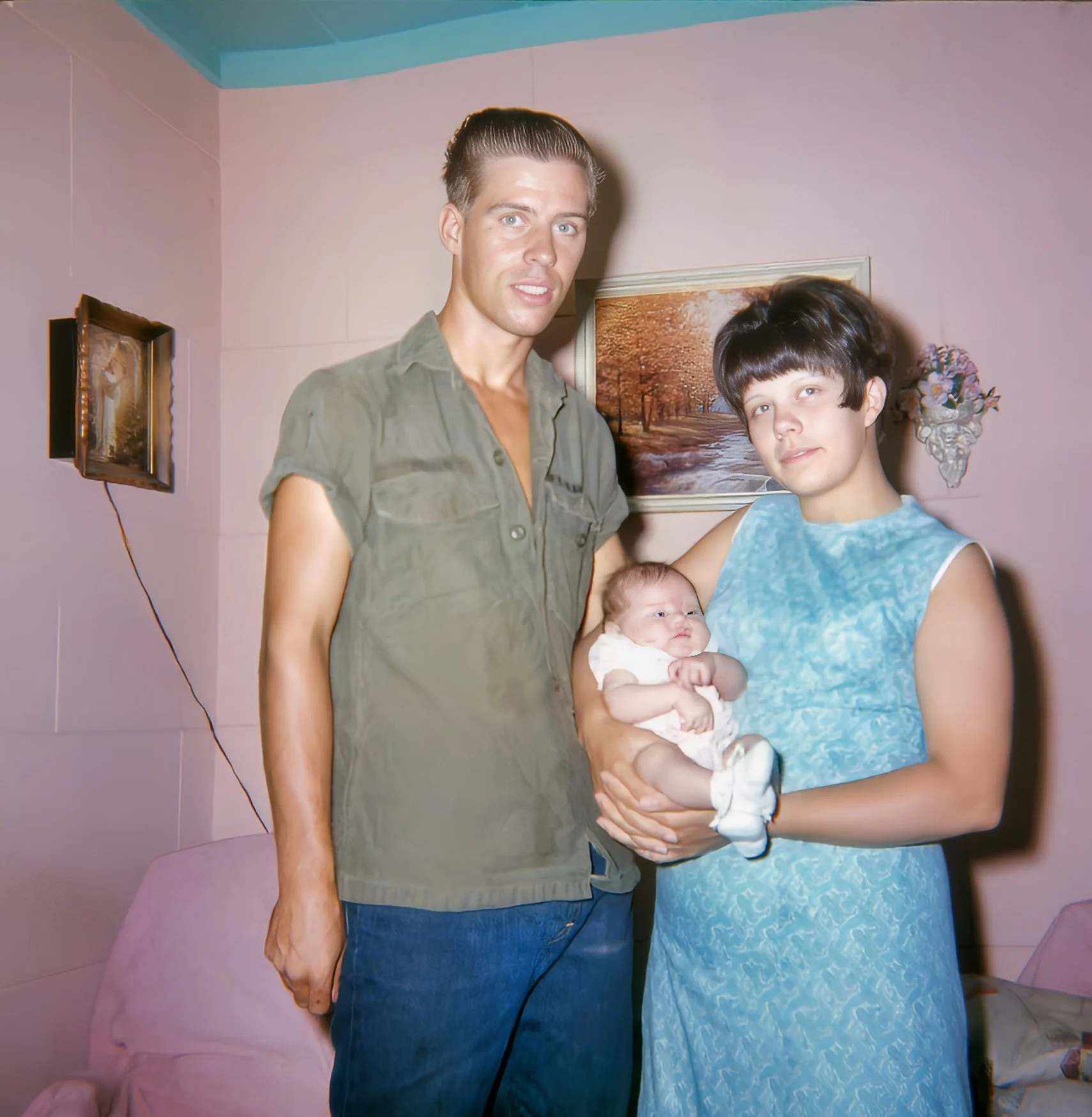 Young parents holding their newborn baby after father returned from Vietnam