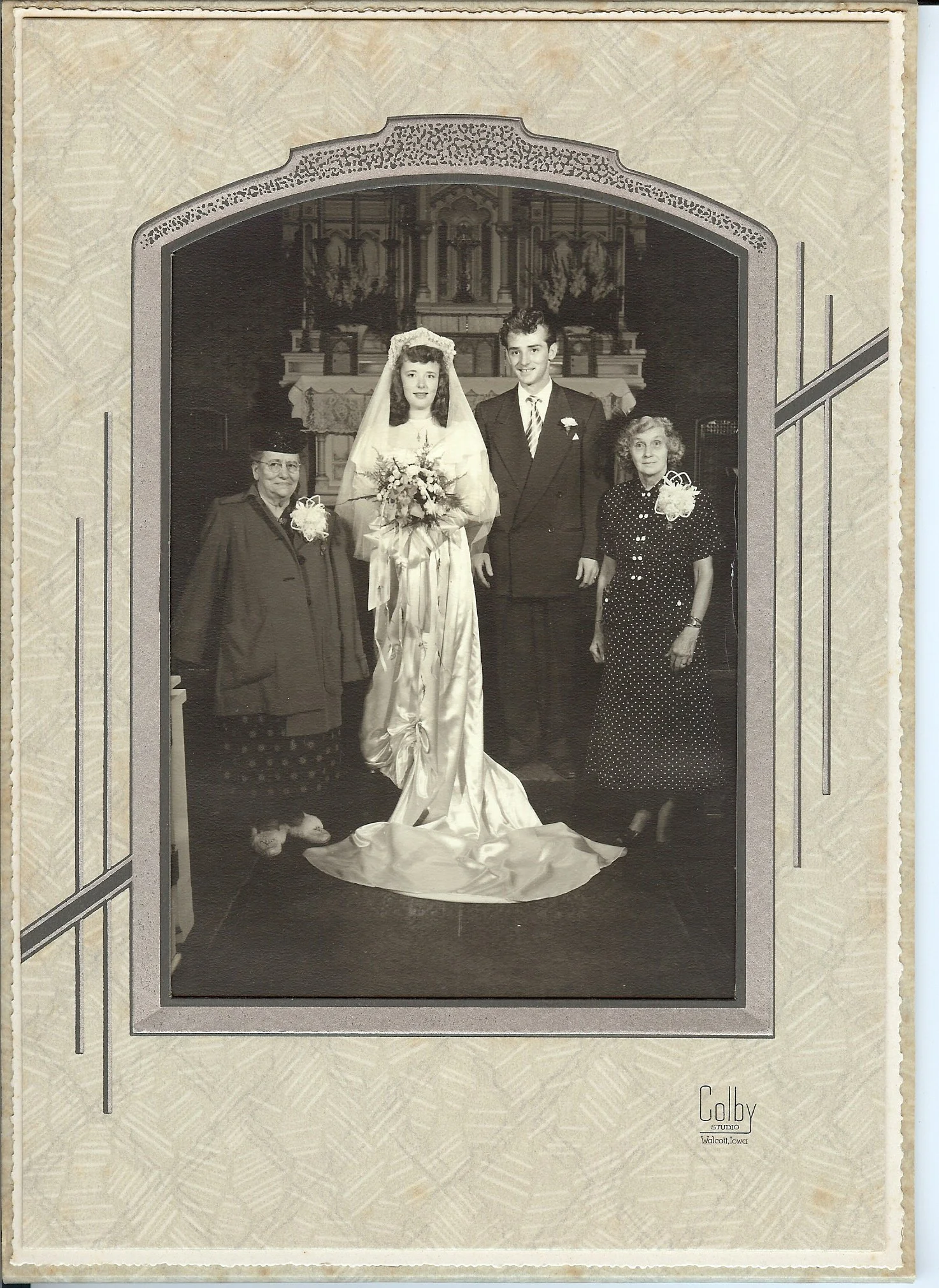 Vintage wedding photo with bride, groom, and family members