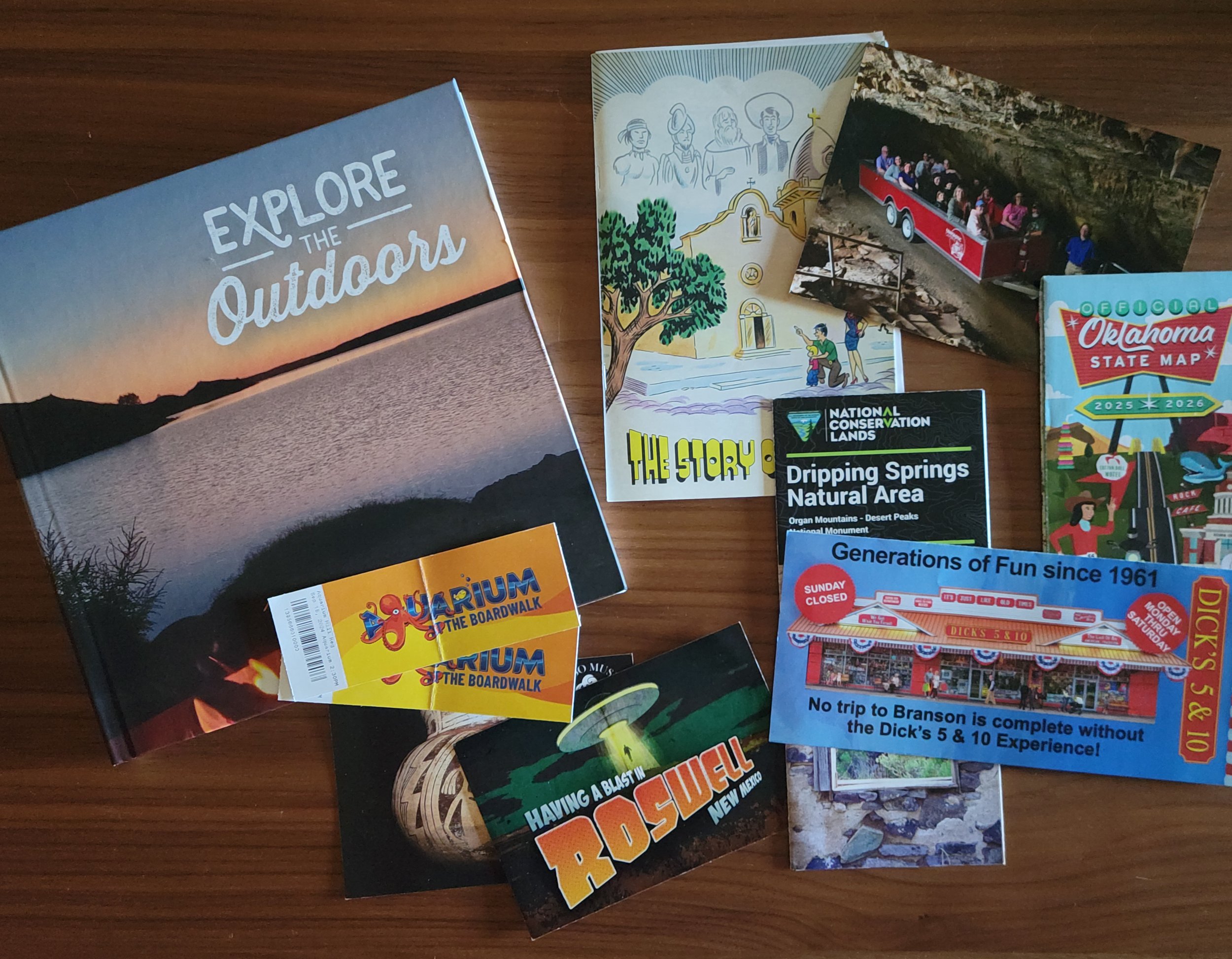 Travel memory book with tickets, maps, brochures, postcards, and trip keepsakes