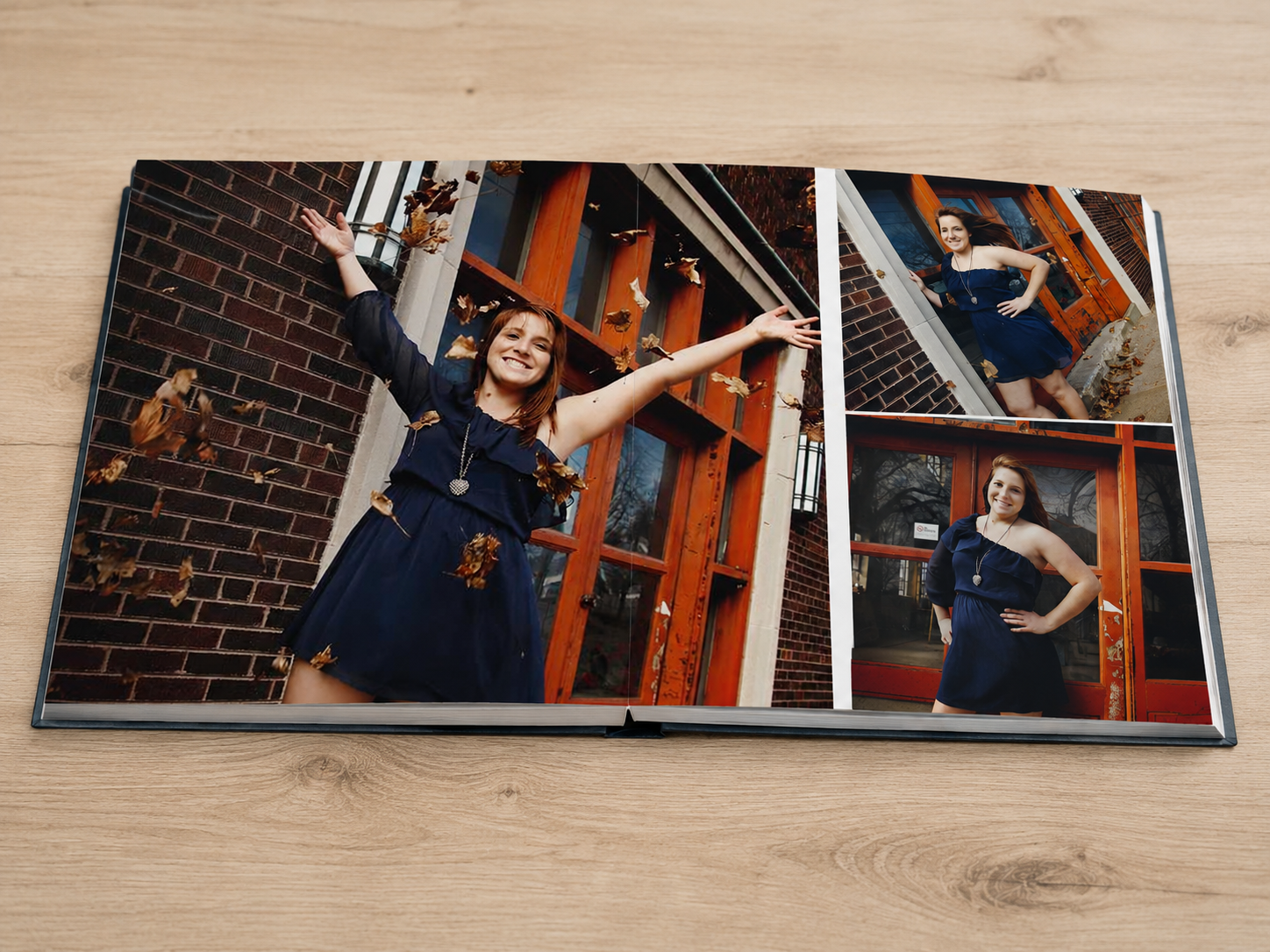 Open signature album with thick layflat pages displaying a custom photo spread on a wooden surface.