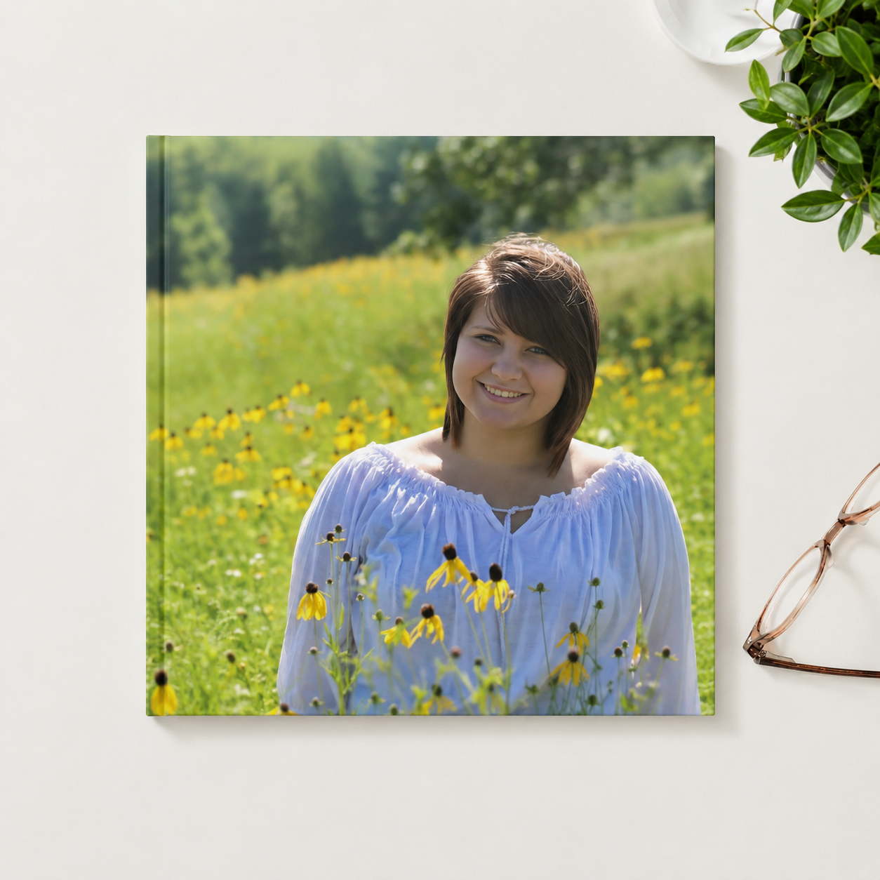 Photo hardcover Snapshot Book featuring a senior portrait on the cover in a simple tabletop setting.