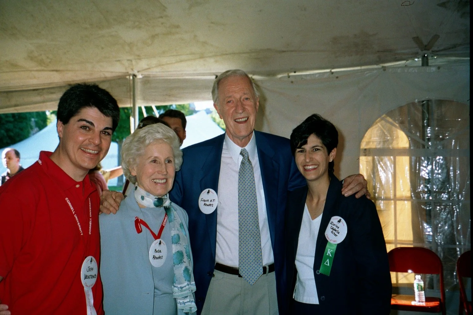 Cornell President Frank H.T. Rhodes and his wife Rosa with Cornell Class of 1991 Reunion Chairs, during Cornell Reunion weekend, smiling in a tent at a social event, wearing name tags and professional attire.