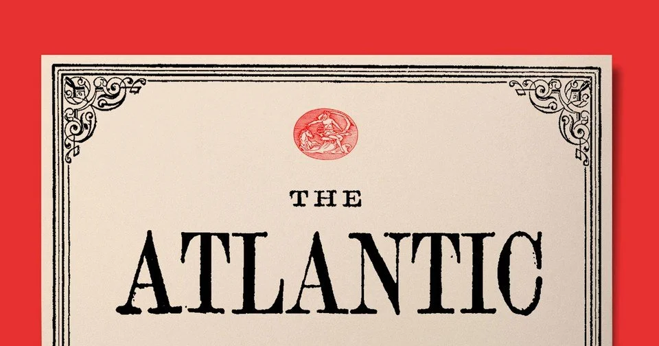 Part of a framed book cover titled "The Atlantic" on a red background with decorative corner designs and a circular red emblem at the top.