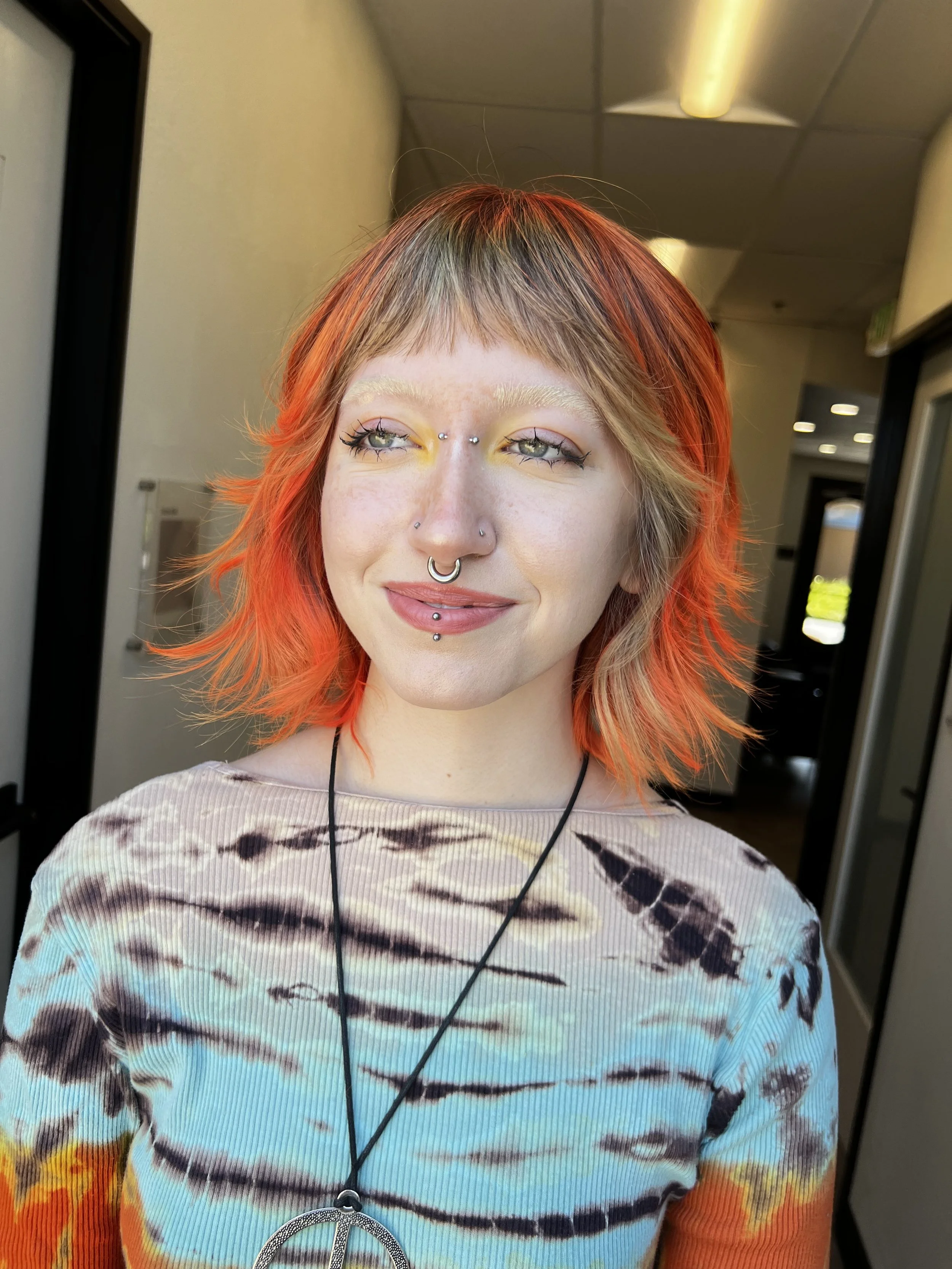 Alt haircut with blonde bangs and bright orange medium layered hair - Vivid Hair Midtown Sacramento, CA