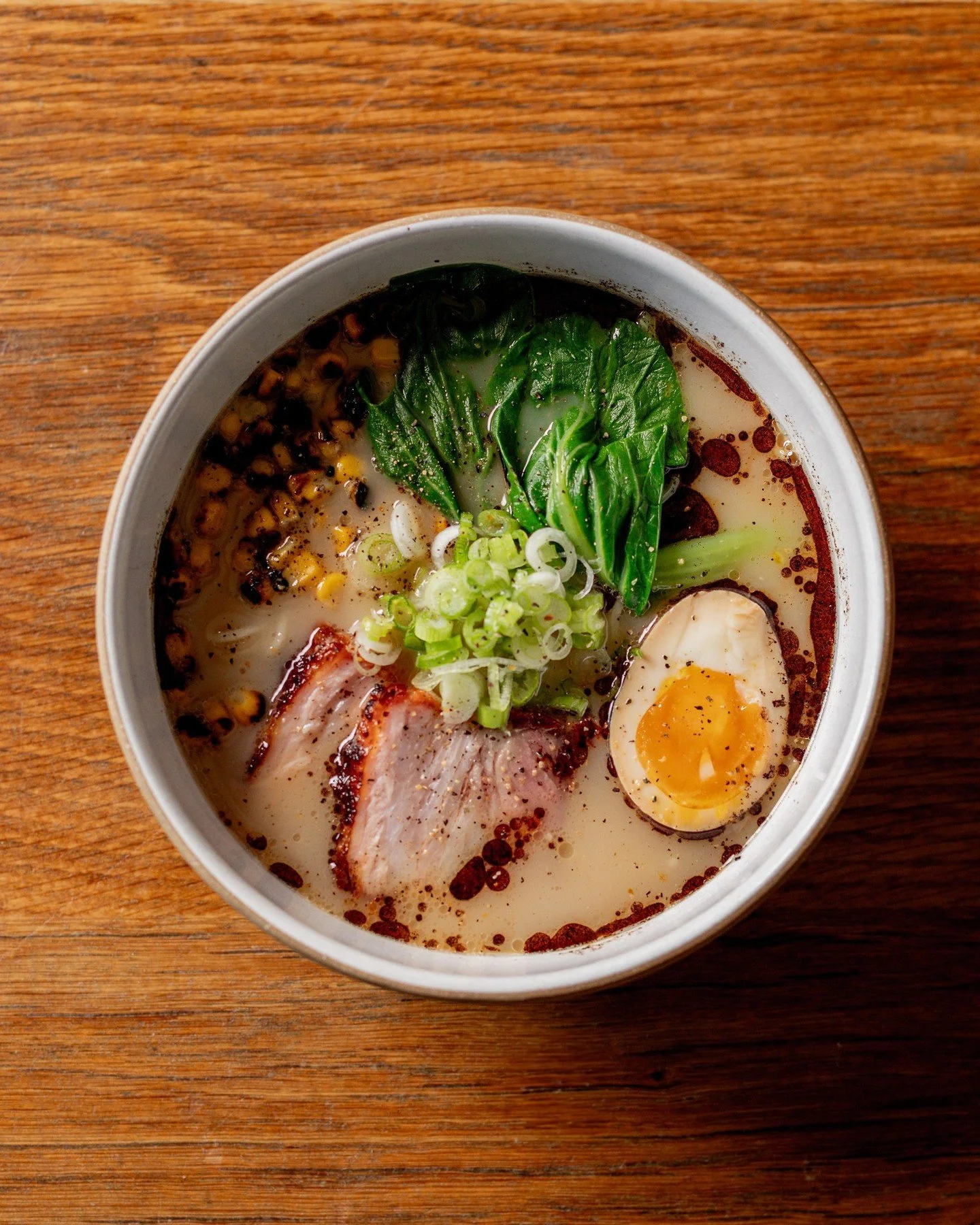Our Pork + Garlic ramen bringing the heat when the cold hits. Pull up.

PORK + GARLIC // braised belly, soy egg, bok choy, charred corn, black garlic, tonkotsu noodles.