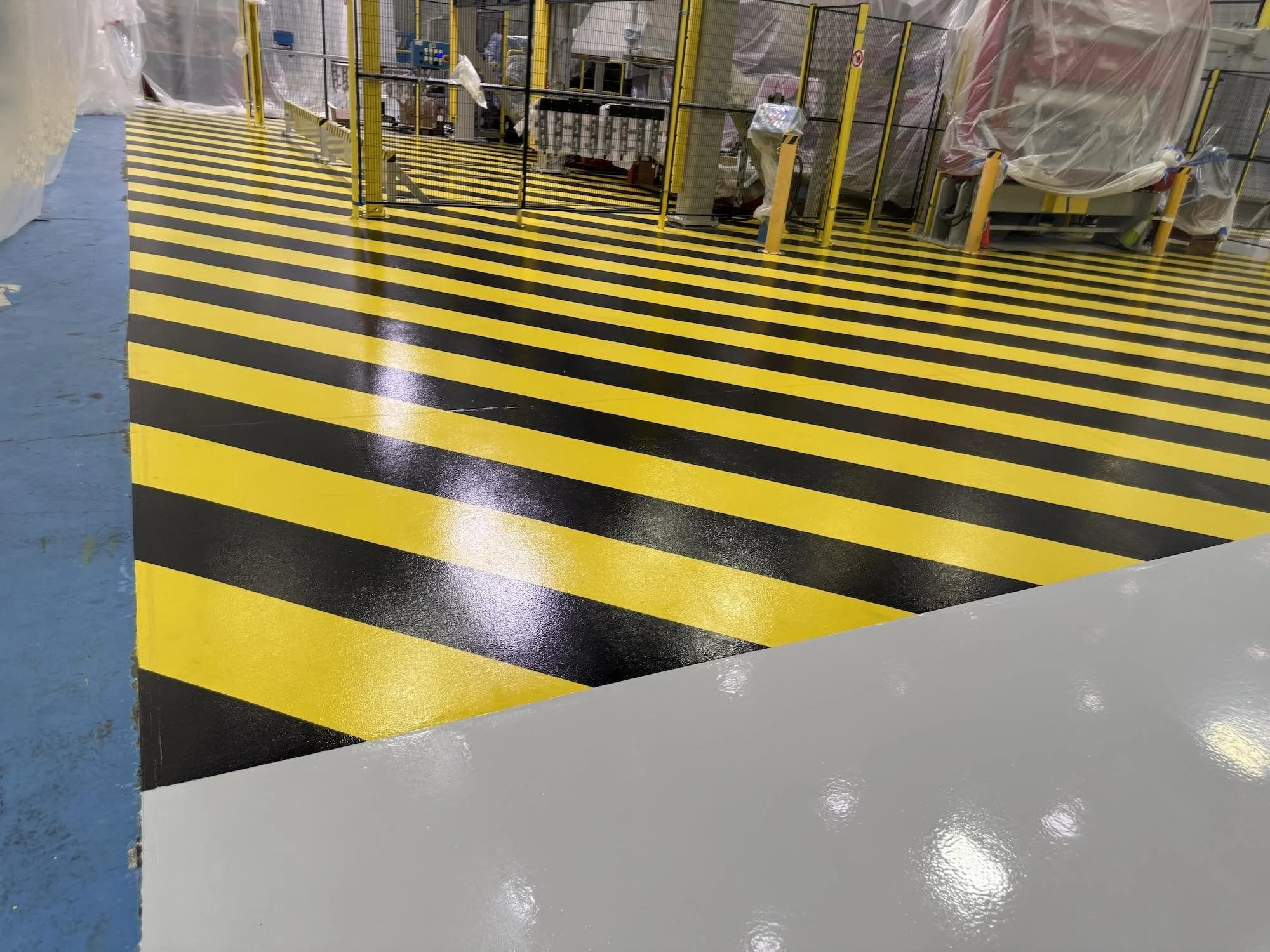 industrial flooring and coating by southern painting for safety with black and yellow stripes