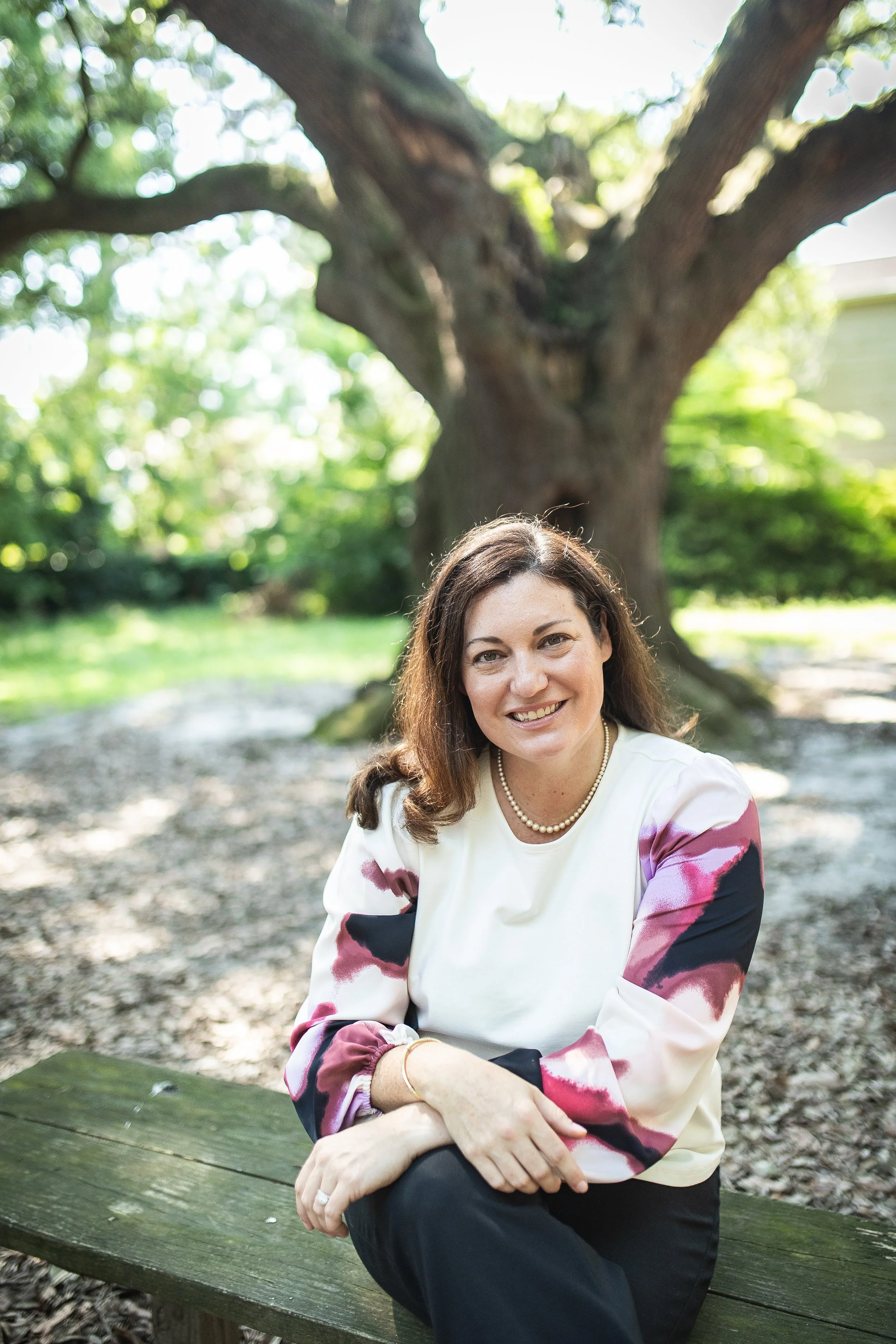 Diana Schofield, PsyD seated outdoors for the Schofield Psychological contact page