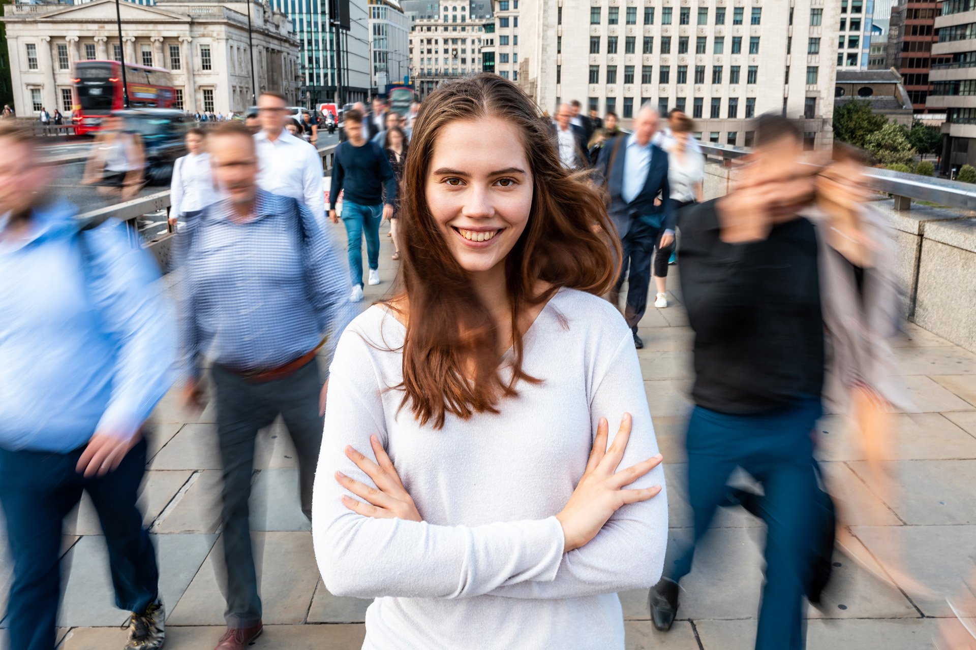 Woman standing confidently in a busy city representing growth through clinical supervision