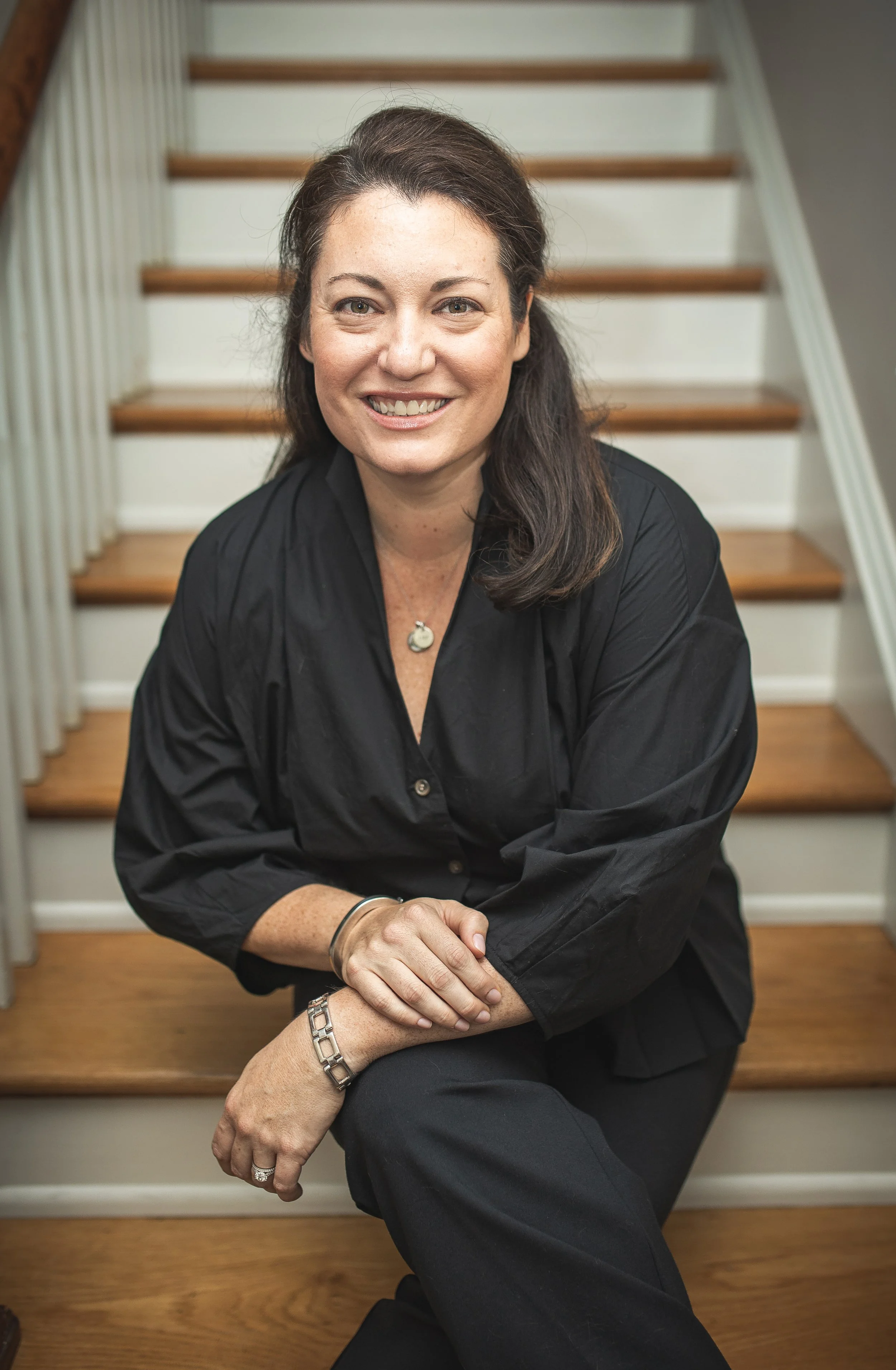 Diana Schofield, PsyD seated indoors for her private practice profile