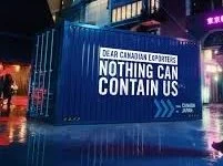 Large digital billboard displays a message saying, 'DEAR CANADIAN EXPORTERS, NOTHING CAN CONTAIN US,' in bright white letters against a dark background.