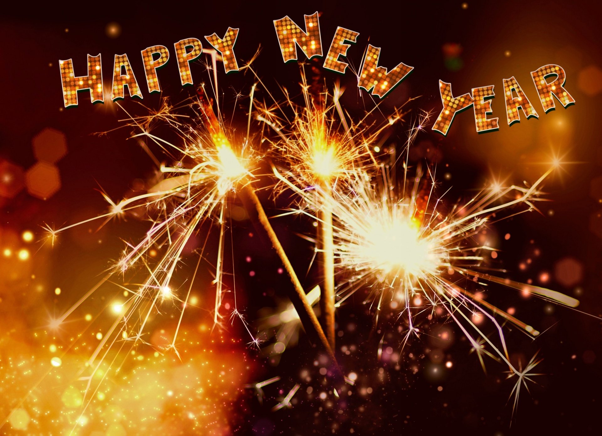 Stylized text saying "Happy New year" above lit sparklers
