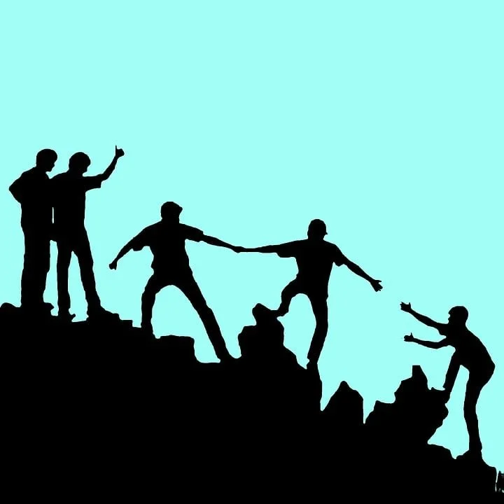Cartoon silhouette of 5 people working together to climb a rocky slope