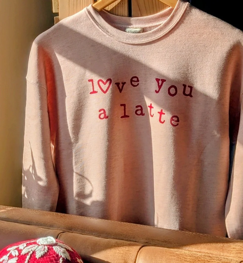 Roses are red,
Violets are blue,
I love you a latte,
With cold foam on top too! 

❤️ Come by the cafe and grab yourself one of these adorable sweatshirts - and a latte to go with it! ☕❤️