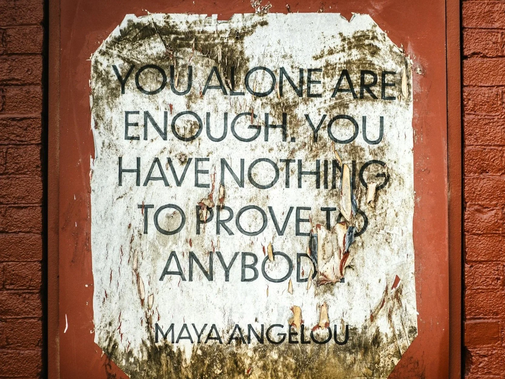 Quote by Maya Angelou on a weathered poster.