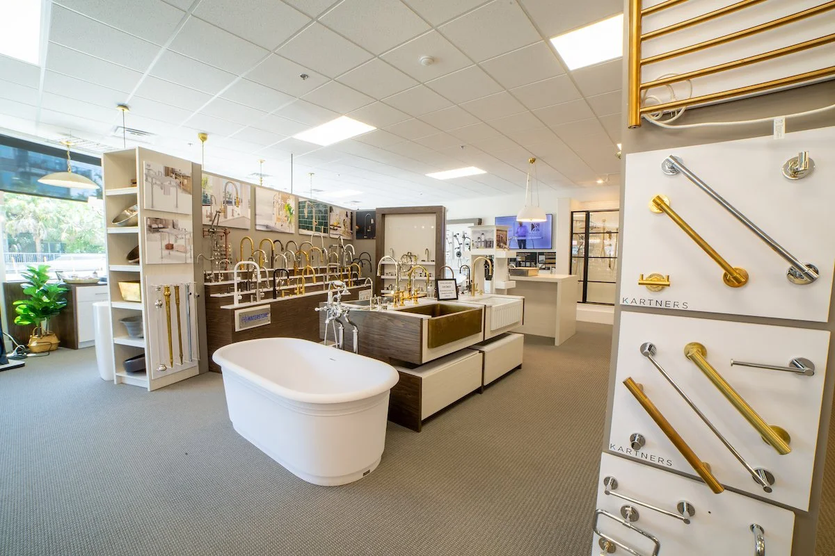 Bathroom faucet display with various faucet styles and finishes in a store showroom.