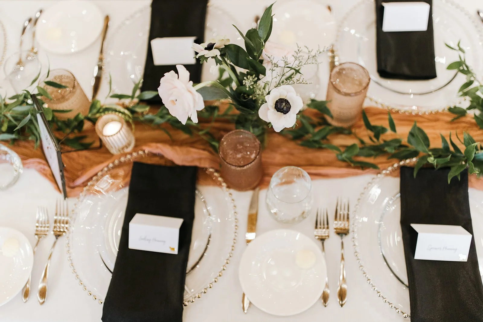 Wedding reception at The Cheney Place in Grand Rapids, Michigan complete wedding tablescape with chargers and contrast napkins