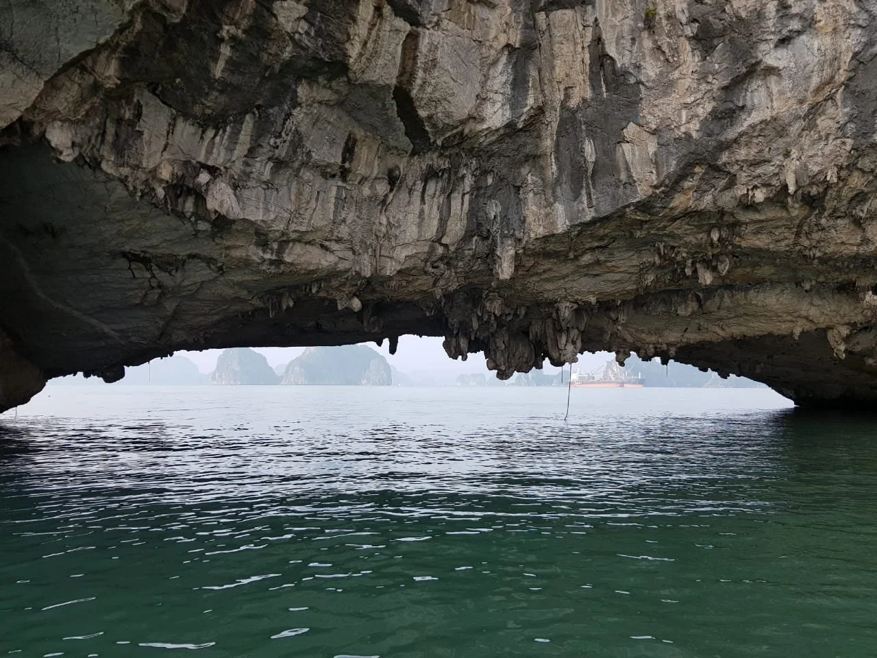 A cave overhanging water taken by Intent Platform