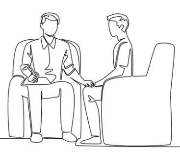 A person in a suit interviewing another person in a chair, holding a pen and notebook.