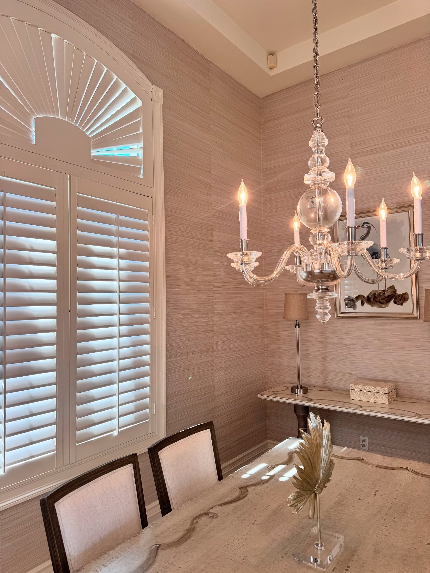 Elegant dinning room with natural grasscloth wallpaper.