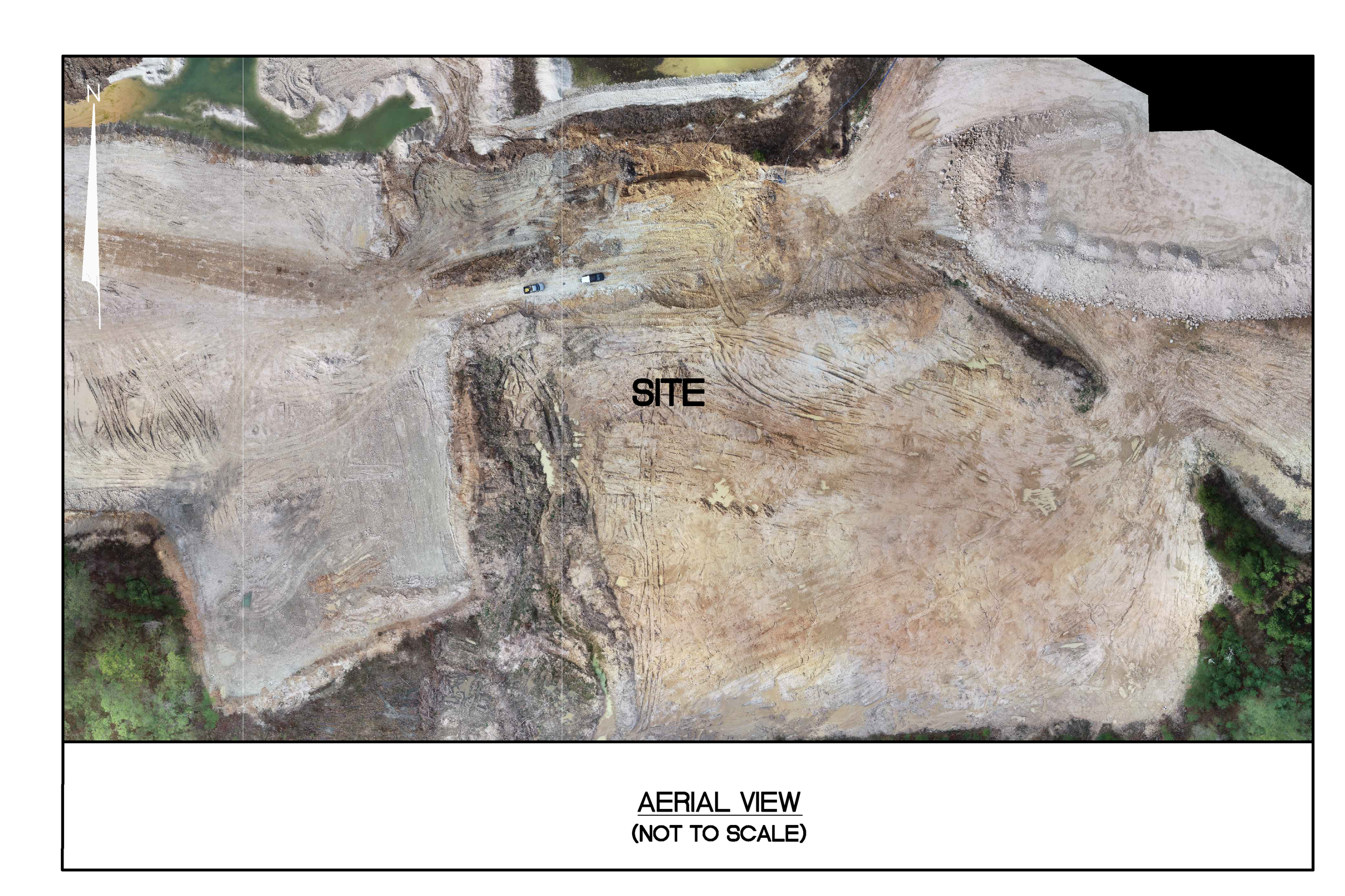 An aerial view of a construction site with dirt and rock excavations. Two vehicles are on a dirt path, and the site is surrounded by some trees. The image has labels indicating 'SITE' and 'AERIAL VIEW'.