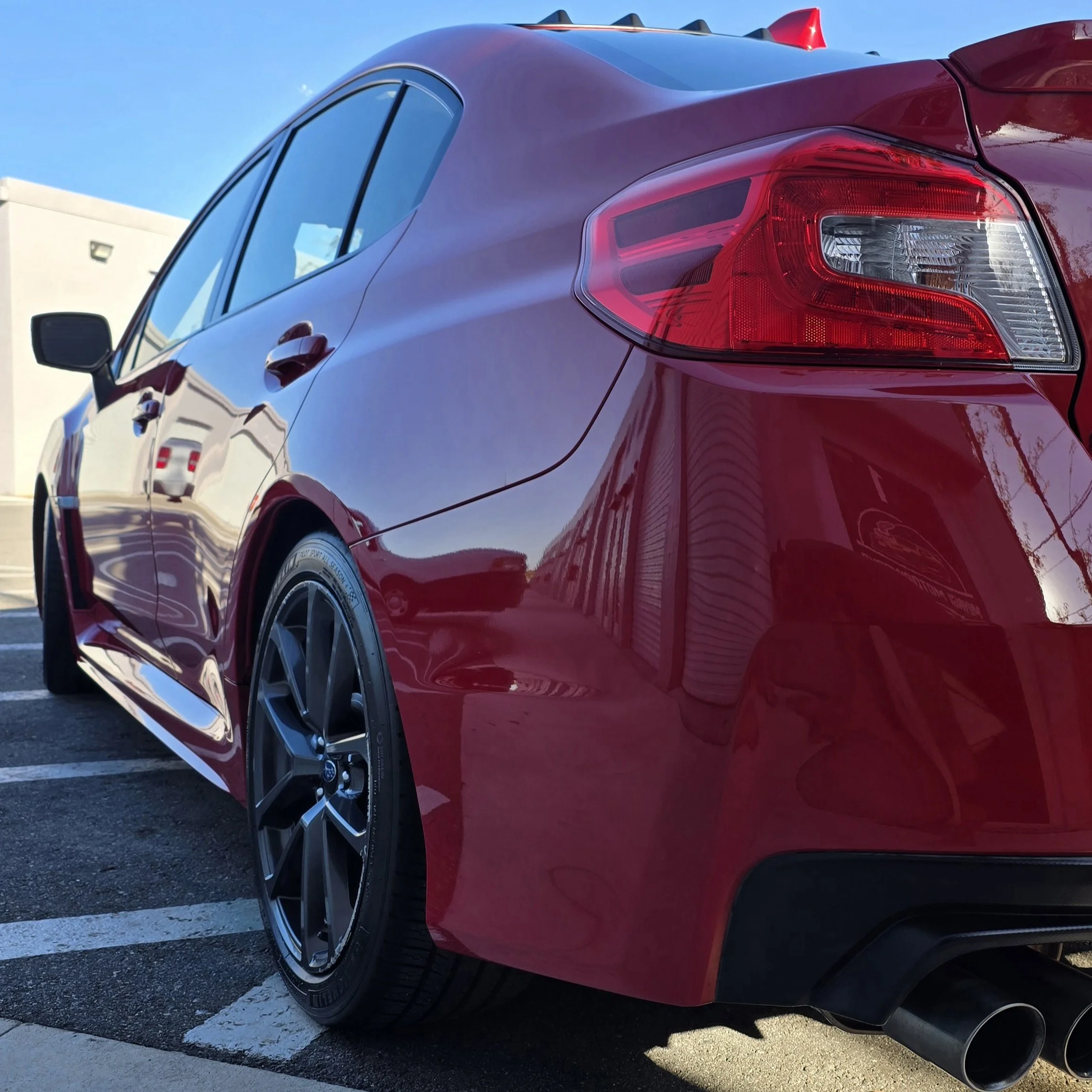 Red Subaru WRX after a two step paint correction and 7-year ceramic coating in front of Miyagi Motorworks