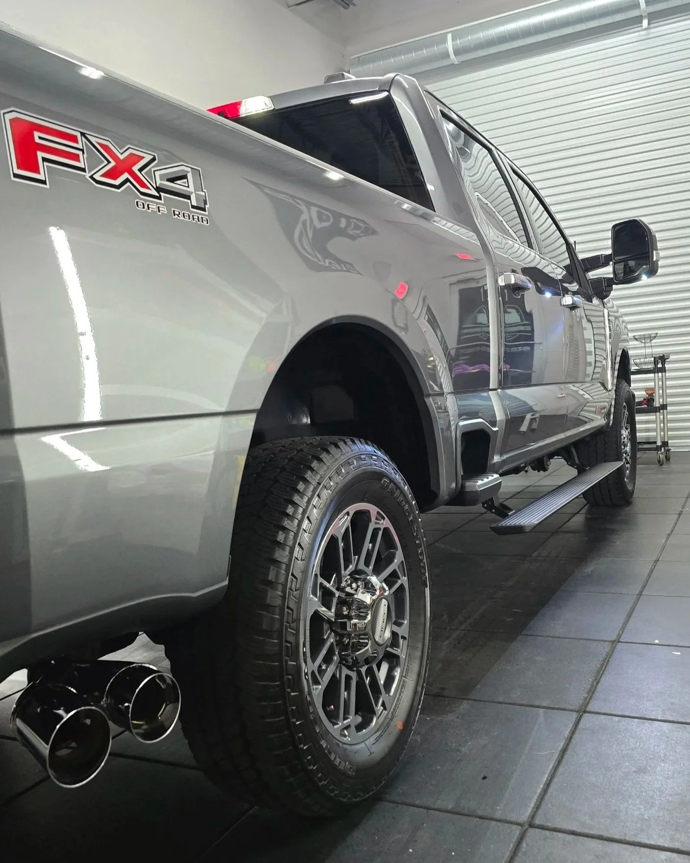 Silver Fx4 Off-Road Ford F-250 after 7-year ceramic coating on paint and wheels inside shop