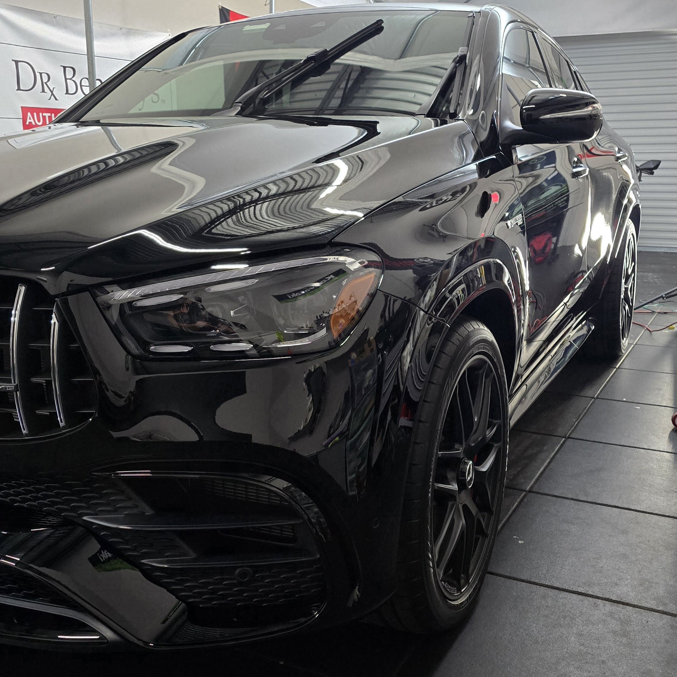Glossy black Mercedez Benz E63 AMG with self-healing ceramic coating inside Miyagi Motorworks studio