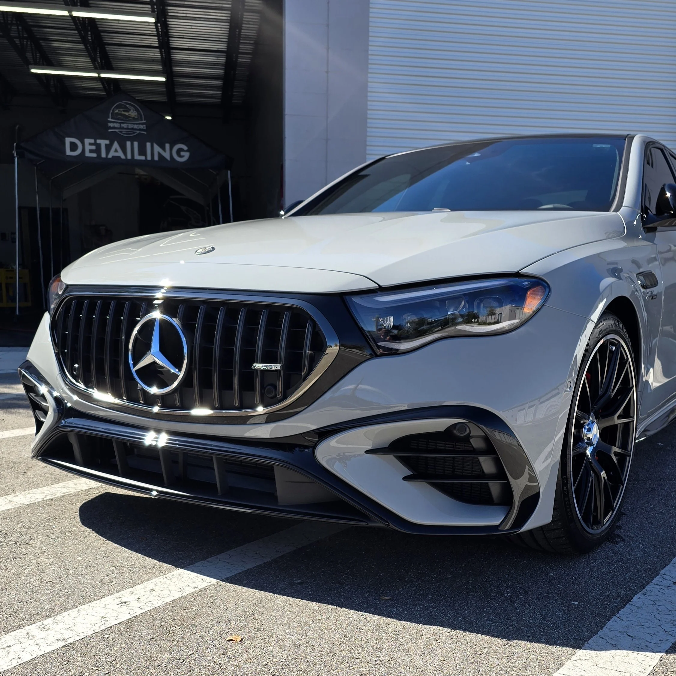 Glossy grey Mercedes-AMG C43 hybrid sedan after a premium 7-year ceramic coating and paint correction service.