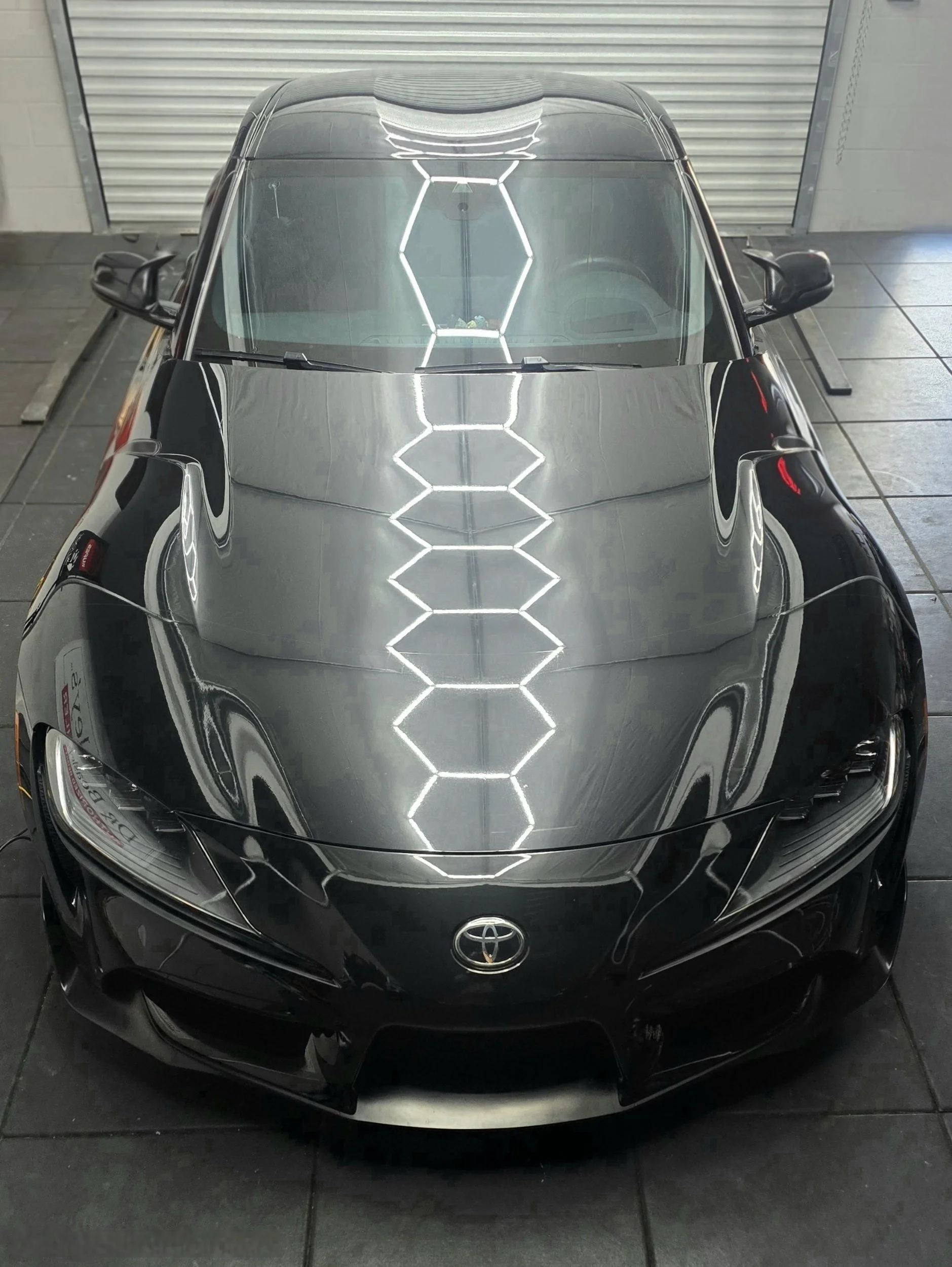 black supra under hexagon lights after ceramic coating