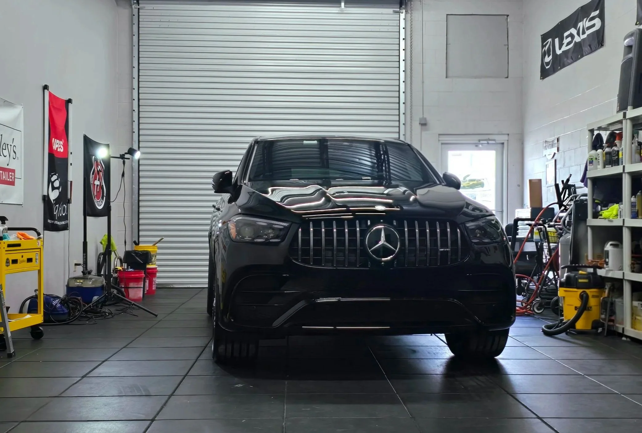 Black Mercedez Benz E63 AMG inside Miyagi Motorworks studio in Largo, FL after self-healing ceramic coating