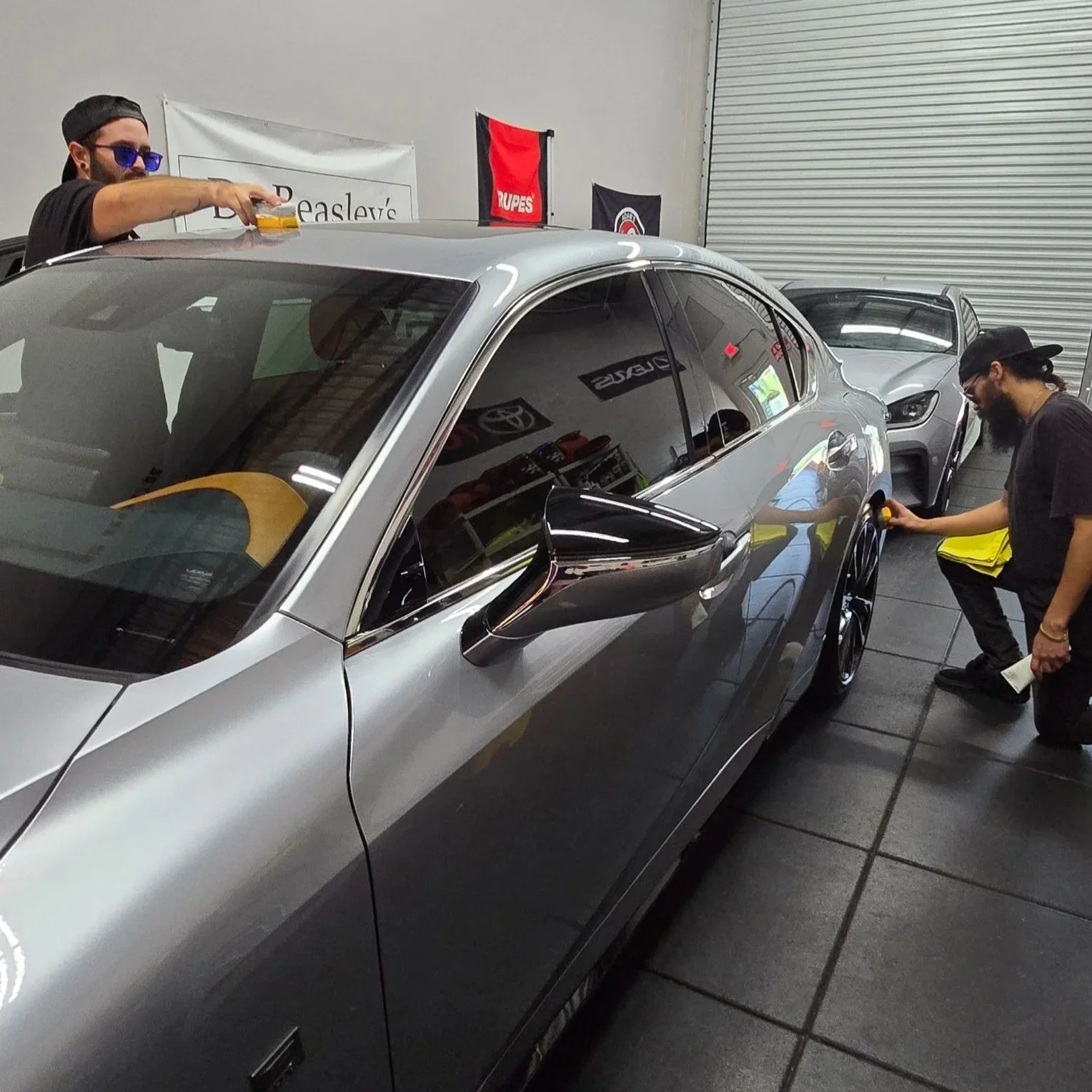owners of miyagi motorworks working on a silver lexus is350
