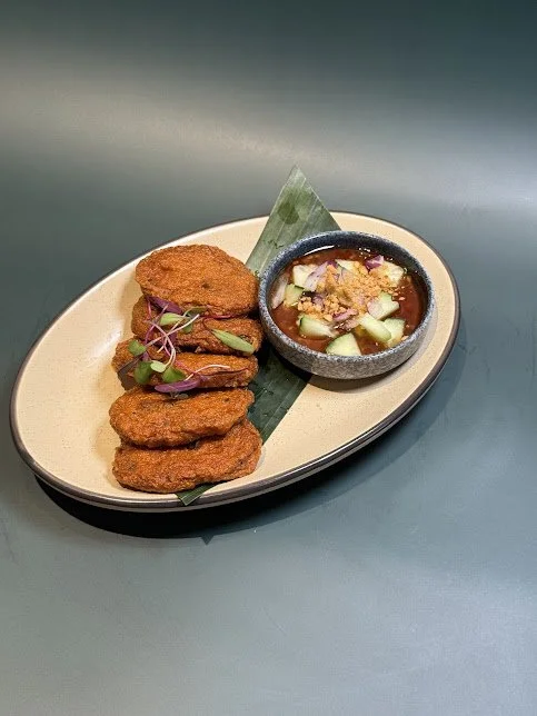 Thai Fish Cakes (5)
These fish cakes are packed with flavor from Thai herbs and spices. Served with Thai sweet chili sauce mixed with fresh cucumber, red onion, and crushed peanuts.
