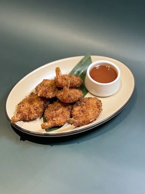 Coconut Shrimps (6)
Crispy marinated coconut crumble shrimp served with sweet and sour sauce.