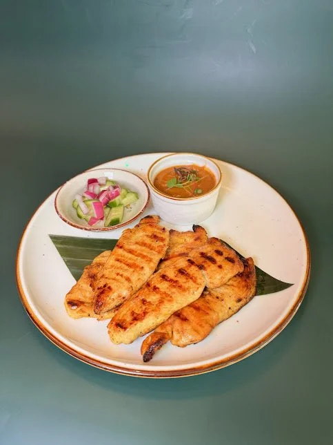 Chicken Satay (5) 
Grilled marinated chicken infused with Thai herbs and spices served with peanut sauce and cucumber salad sauce.