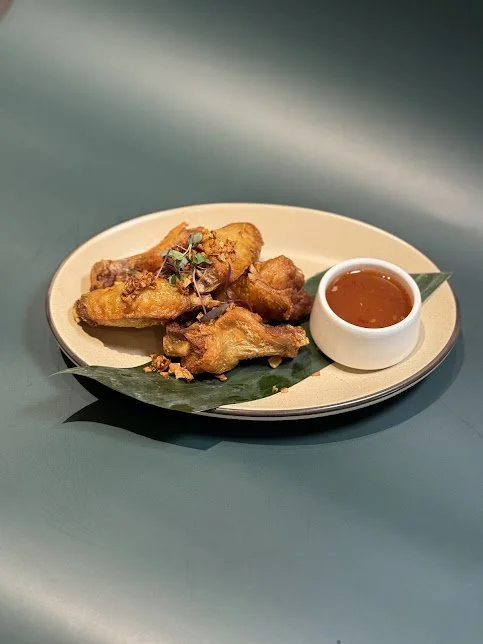 Chicken Wings (5)
Marinated chicken wing topped with fried garlic served with sweet chilli sauce.