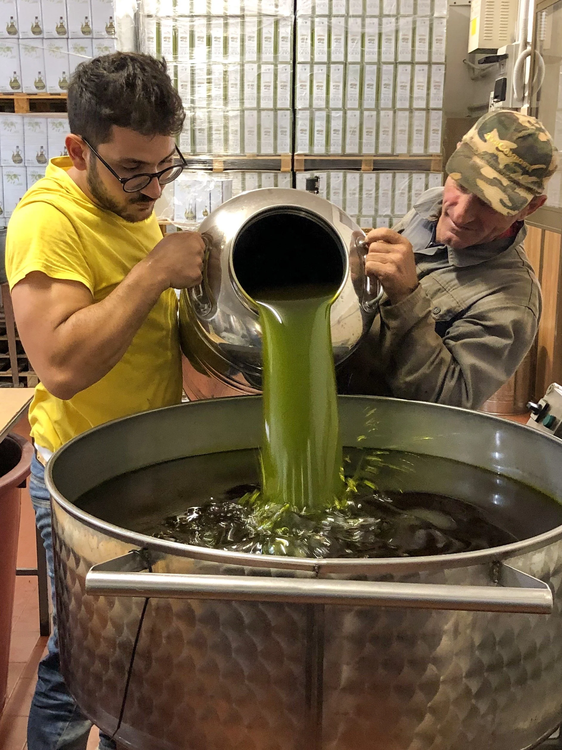 freshly pressed green olive oil being poured