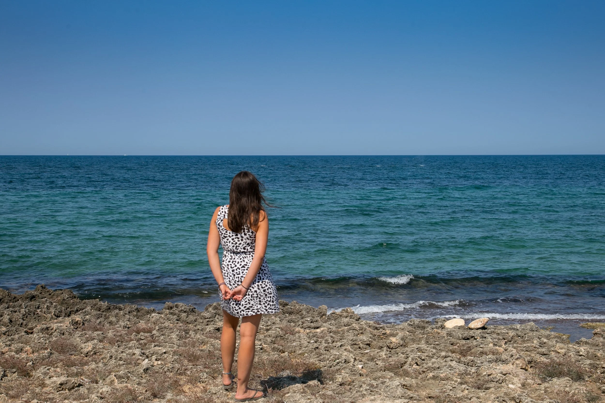 person gazing at the sea on the Puglia coast