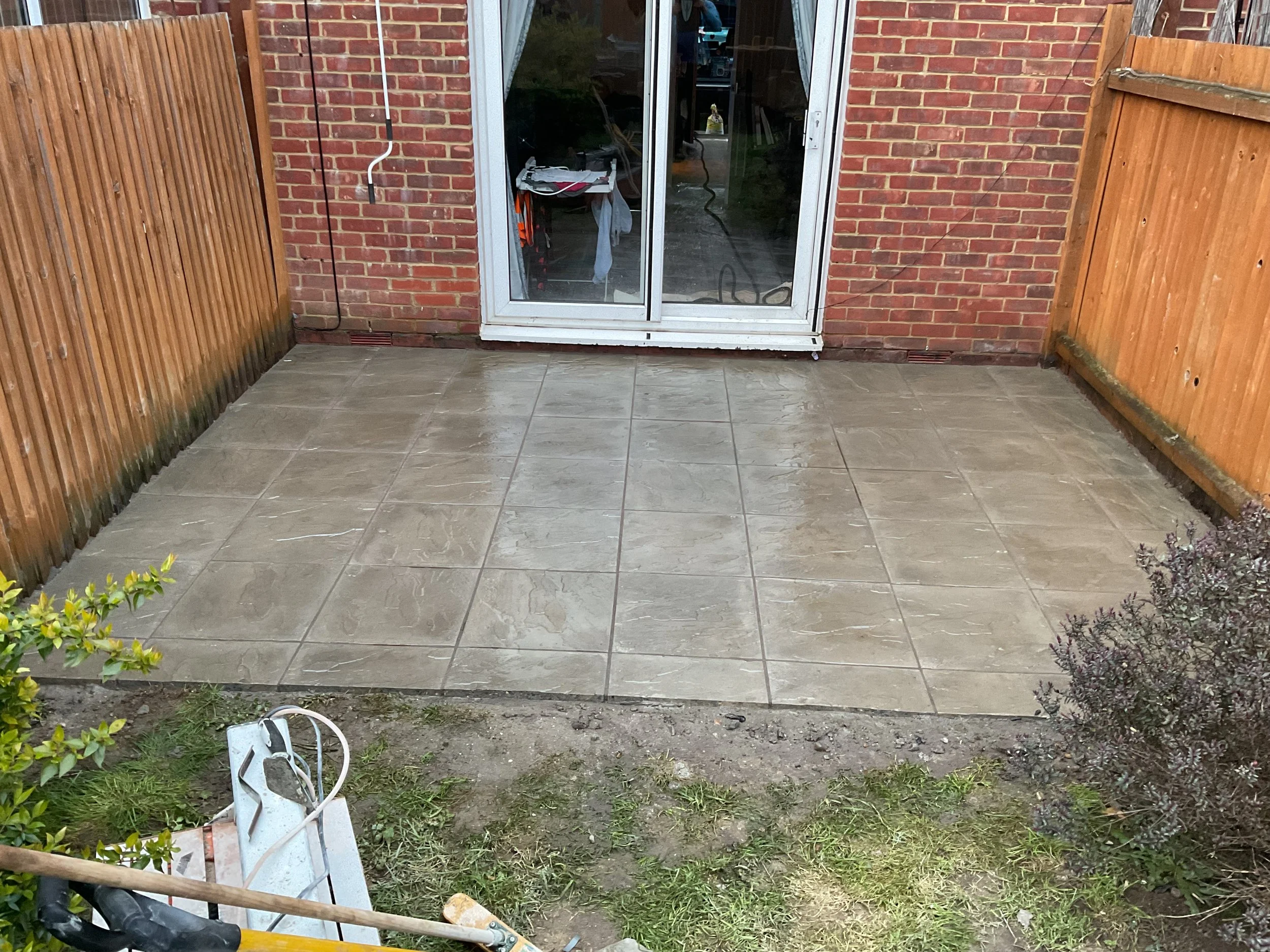 Stone patio backyard, replacing old wooden patio