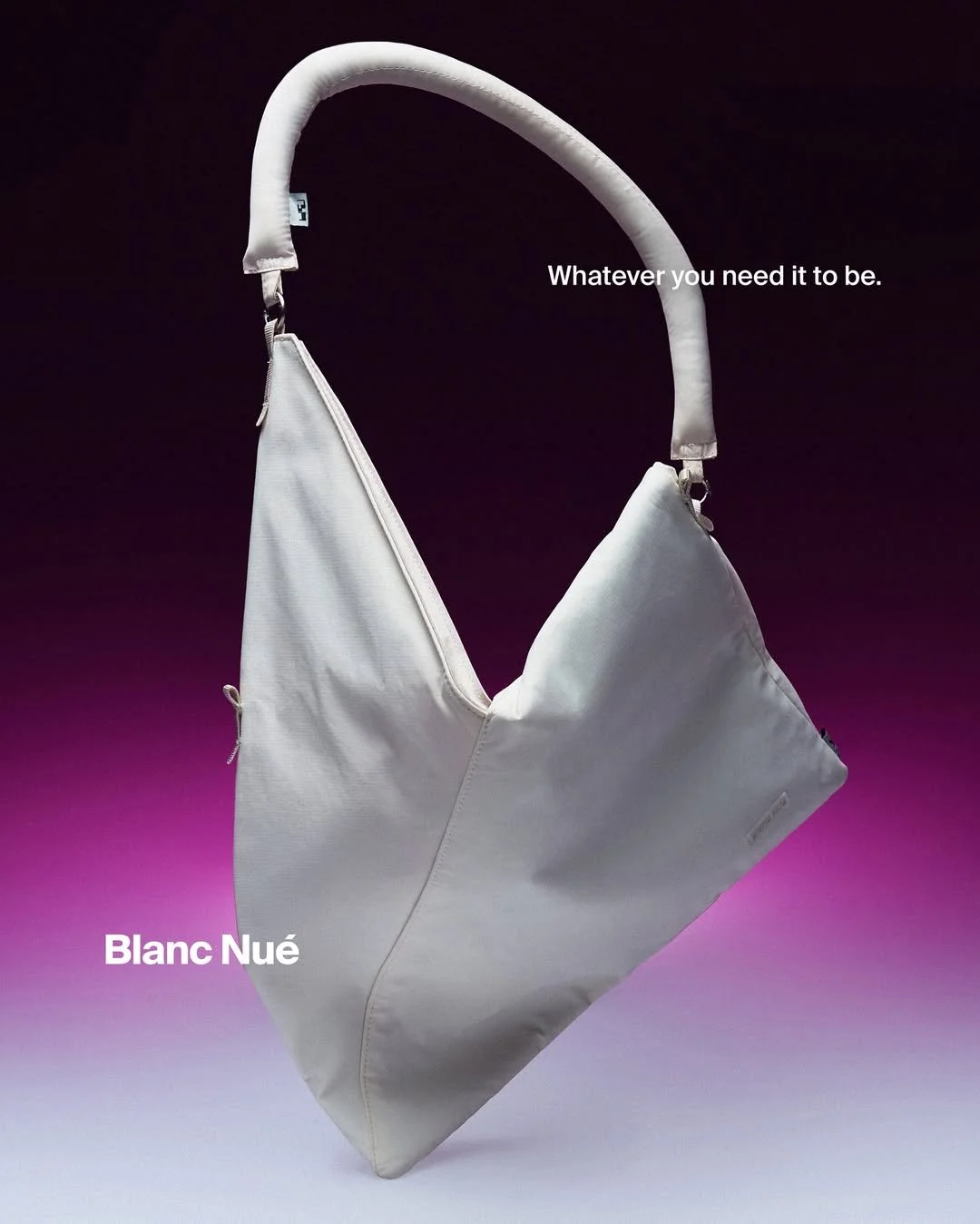 A white bag with a padded handle against a black and purple gradient background, with the text 'Whatever you need it to be.' and 'Blanc Nué' displayed.