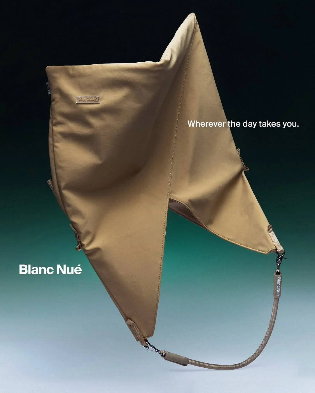 A beige bag with a strap and zipper, set against a dark background with text saying "Blanc Nué" and "Wherever the day takes you."