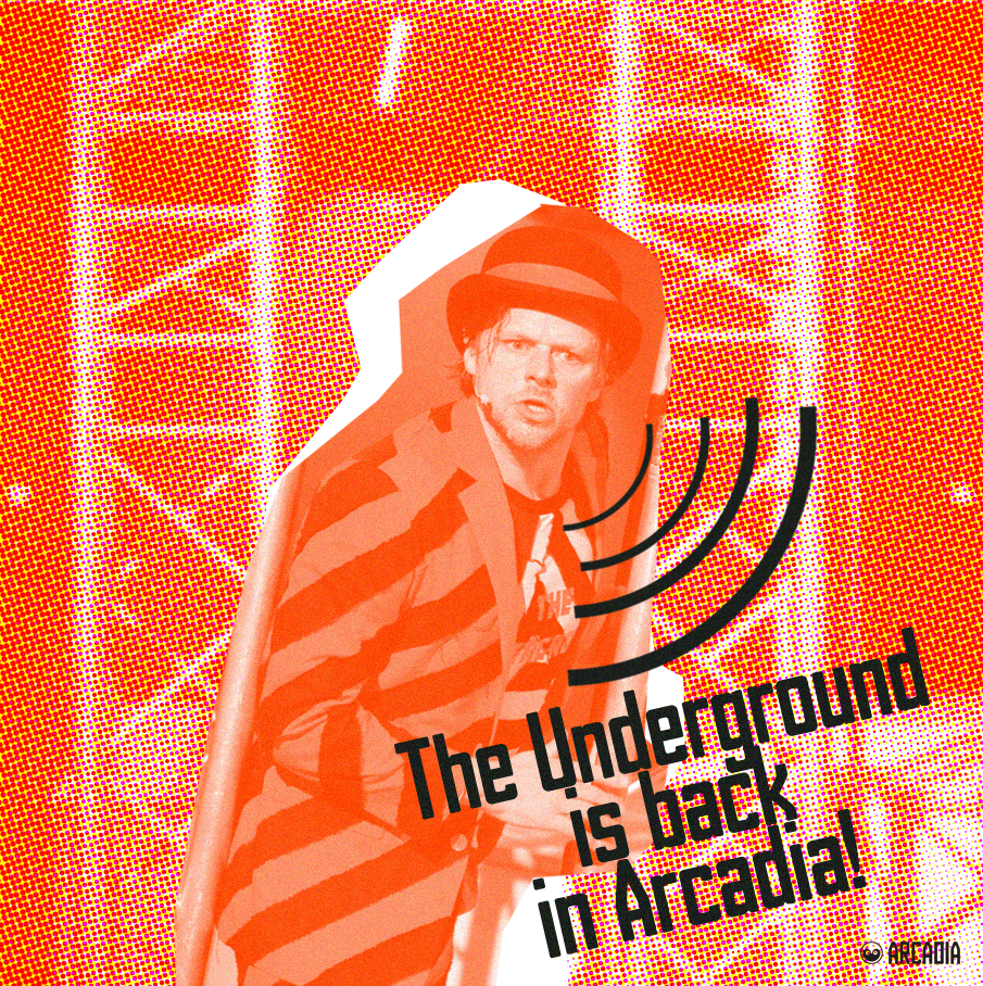 Costumed man with a serious expression, wearing an orange and black striped jacket and a helmet, inside a red-toned digital art background resembling a subway or arcade environment. Text overlay says, 'The Underground is back in Arcade!' with sound wave graphics and small Arcadia logo.