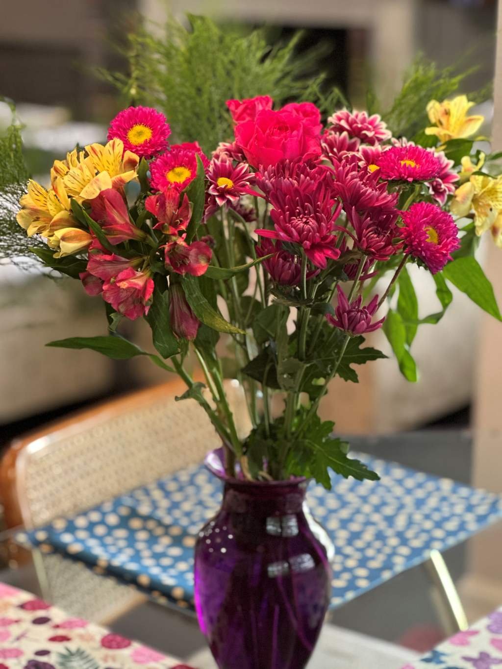 Bouquet of Pink & Yellow Flowers in purple glass vase